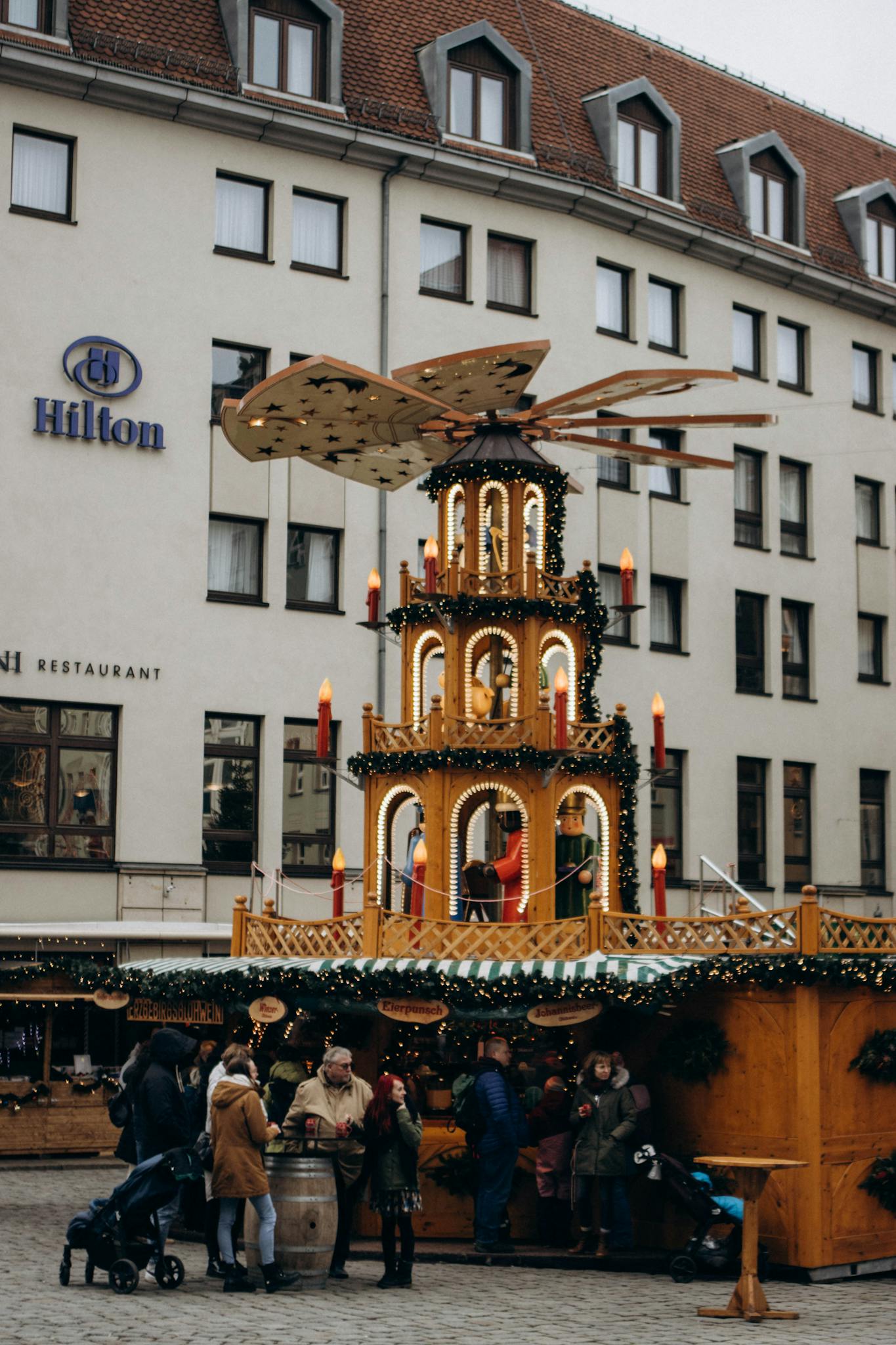 Festive Christmas market with traditional decorations and a bustling crowd.